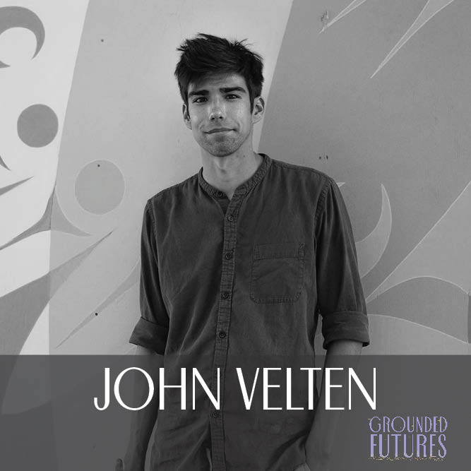 A person looking directly at the camera. They are wearing a dark long sleeved shirt pushed up to their elbows. The image is cut off at their hips. They are leaning against a wall with abstract formline painting on it. A transparent grey box at the bottom holds text that reads "John Velten" and the grounded futures logo is in the bottom right corner