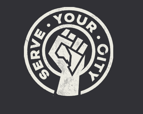 Dark background with a white circle. Withing the circle it reads "serve your city" with a fist through the centre of the circle