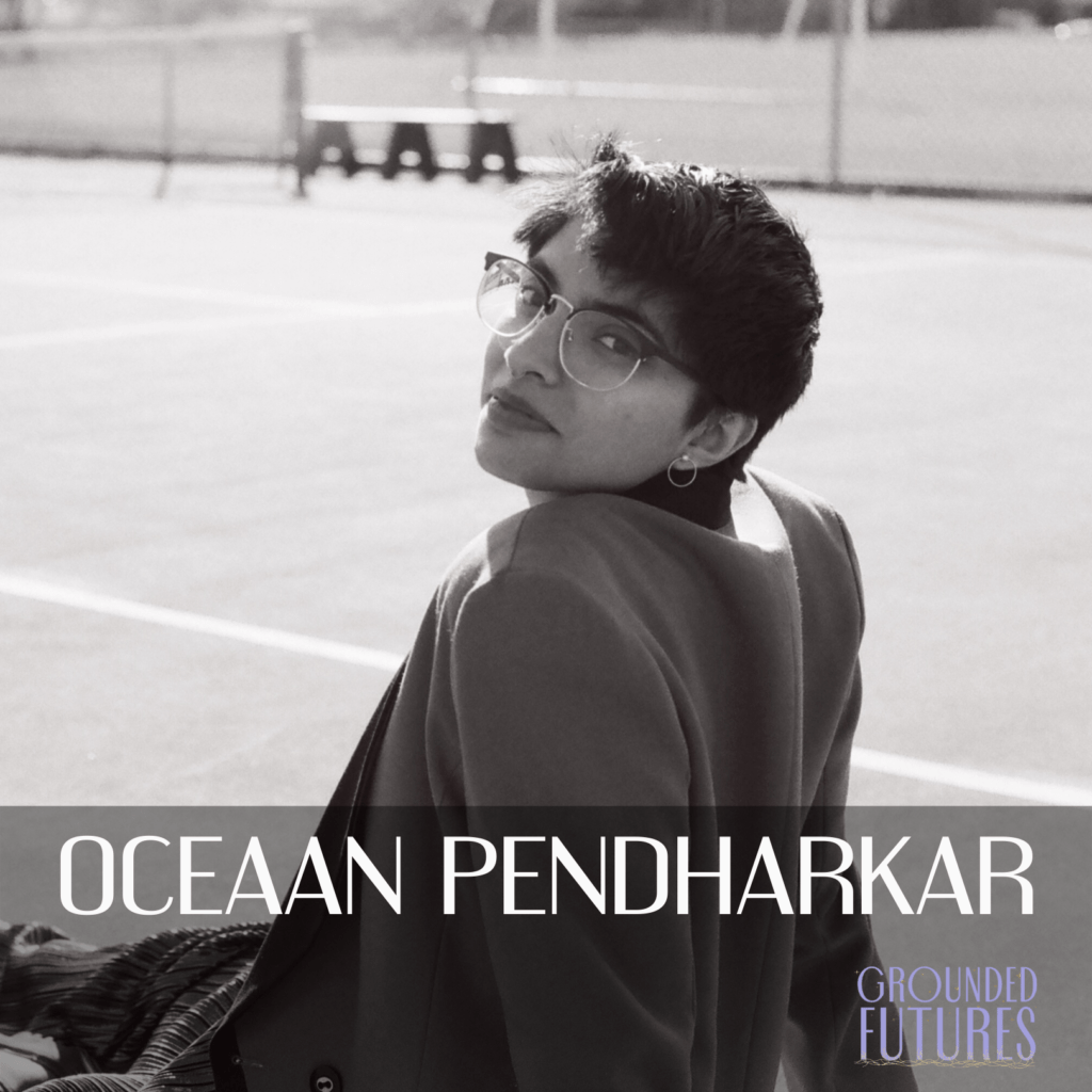 Black and white photo of Oceaan, siting on a tennis court. They are wearing a blazer and looking over their shoulder at the camera. There is text that reads: "Oceaan Pendharkar" and a logo for Grounded Futures in the bottom right corner.