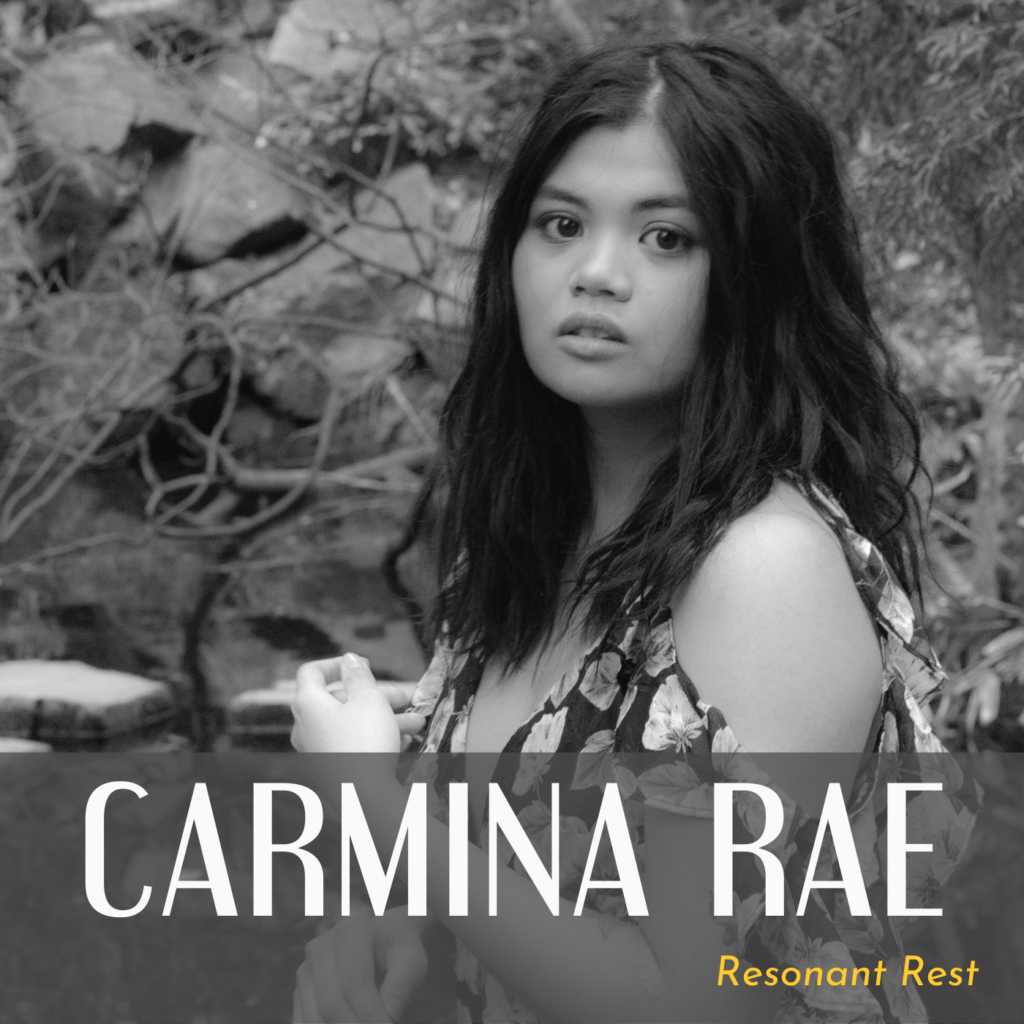 Black and white photo of Carmina outside, standing in front of a rock face and branches. There is text that reads: “Carmina Rae” and it says “Resonant Rest” in the corner in yellow text.